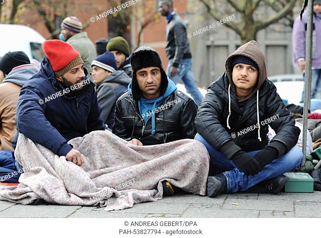 Refugees sit in front of a tent at Sendlinger Gate in Munich, Germany, 24 November 2014. For three days, an international group of refugees has been protesting...
