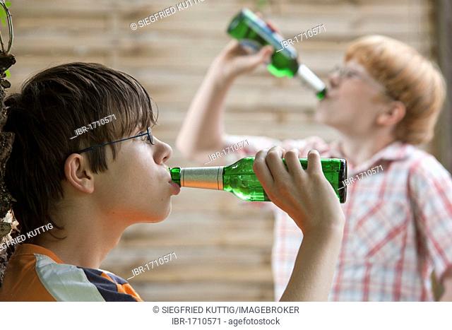 Two under-age teenage boys drinking beer, posed scene
