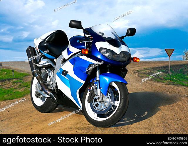 Beautiful brilliant motorcycle on country road against the sky