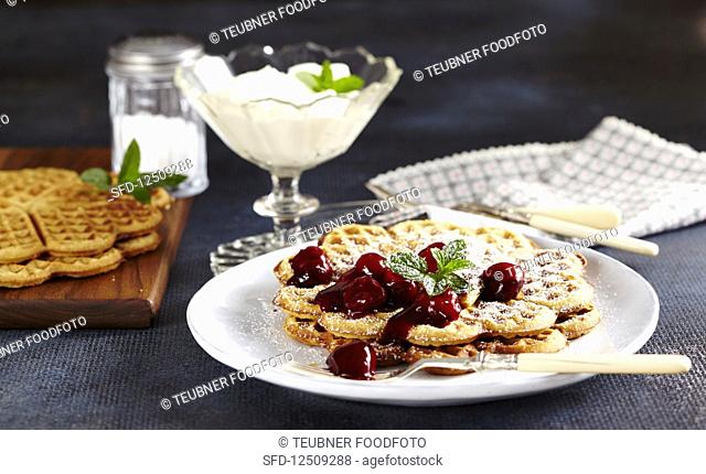 Cinnamon waffles with spiced red wine cherries and whipped cream