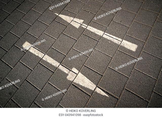 Directional arrows on a paved street