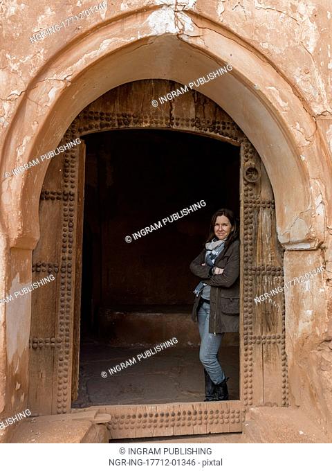 Woman standing at the doorway of Kasbah of Glaoui, Telouet, Ouarzazate, Souss-Massa-Draa, Morocco