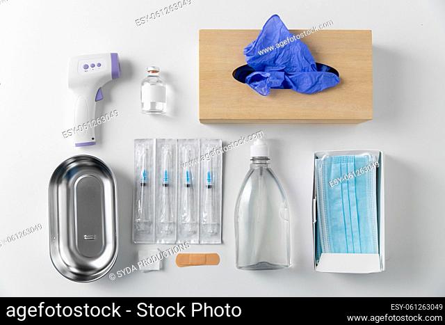 syringes, mask, gloves and other stuff on table