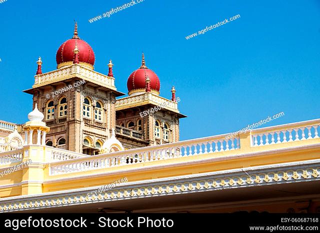 Towers of Mysore Palace with red domes on blue sky, Mysore, India
