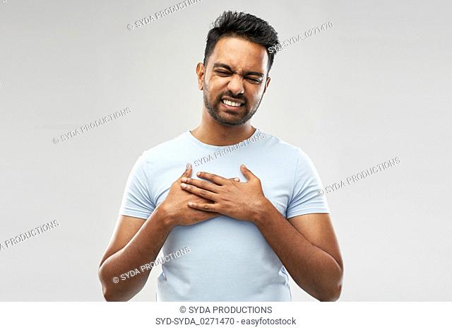 unhappy indian man suffering from heartache