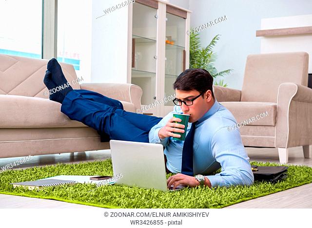 Businessman taking work home and working overtime