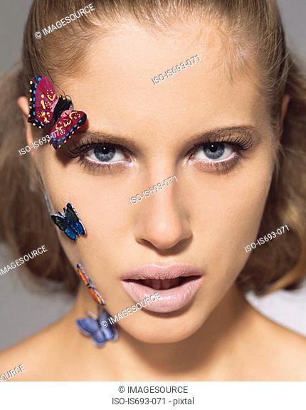 Woman with butterflies on her face