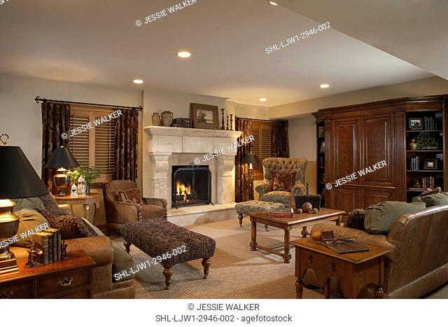 LIVING ROOM: BASEMENT traditional neutral color theme, stone fireplace, shutters and ring top curtains, large media cabinet and display shelves on either side