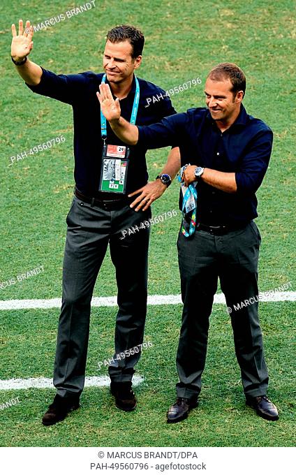 Germany's team manager Oliver Bierhoff (L) and assistant coach Hans-Dieter Flick cheer to the crowd prior to the FIFA World Cup 2014 group G preliminary round...