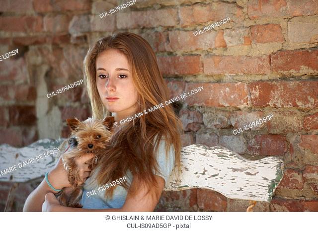 Teenage girl on bench with dog