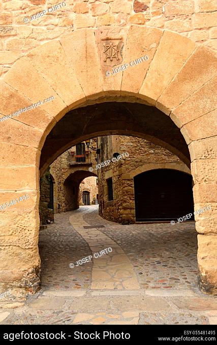 arch of main square of the old town of medieval village of Pals, Girona province, Catalonia, Spain