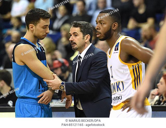 Berlin Alba manager Ahmet Caki (C) talks to Alba player Ismet Akpinar (L) while Khimki Moscow player Jacob Pullen looks on during the Eurocup preliminary round...