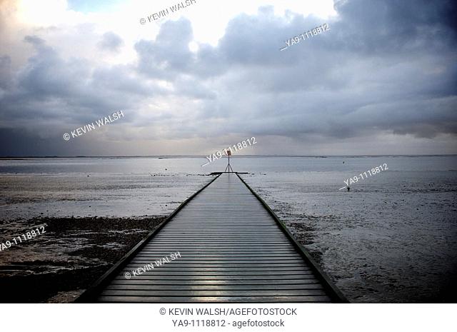 Jetty and storm clouds