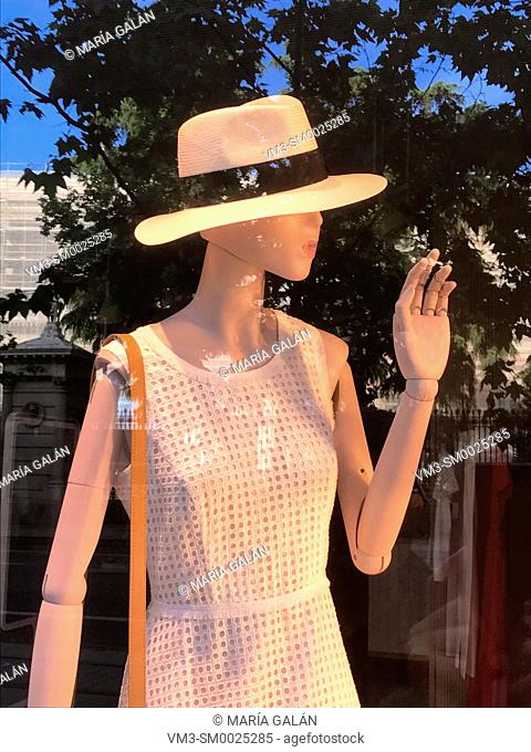 Mannequin wearing summer hat in a shop window. Madrid, Spain