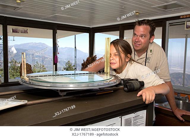 Twin Peaks, California - U S  Forest Service volunteer at the Strawberry Peak fire lookout tower, teaches his daughter, 10
