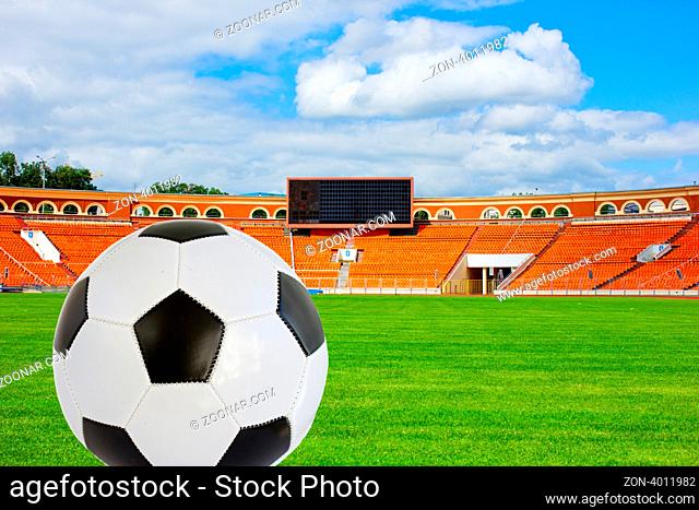 Soccer ball on the green football field