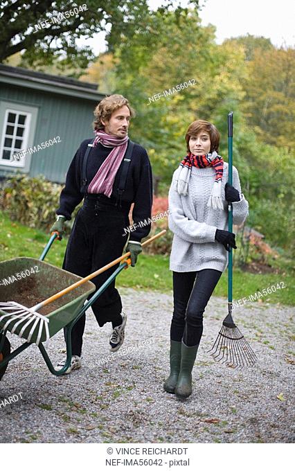 A young couple working in the garden Sweden
