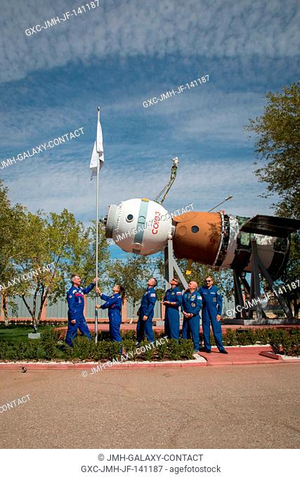 Outside the Korolev Museum at the Baikonur Cosmodrome in Kazakhstan, the Expedition 4142 prime and backup crews participate in the raising of the flag bearing...