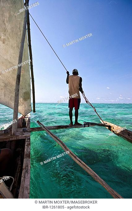 Arab dhow sailing in a blue lagoon, Zanzibar, Tanzania, Africa