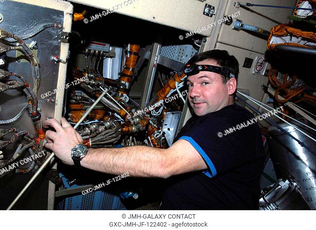 Cosmonaut Yury Lonchakov, Expedition 18 flight engineer, takes a moment for a photo while performing in-flight maintenance on the Komparus A3 System in the...