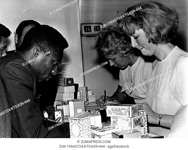July 24, 1966 - London, England, U.K. - Brazilian soccer player EDSON NASCIMENTO 'PELE' buying gifts at the London Airport during a long delay on the arrival of...