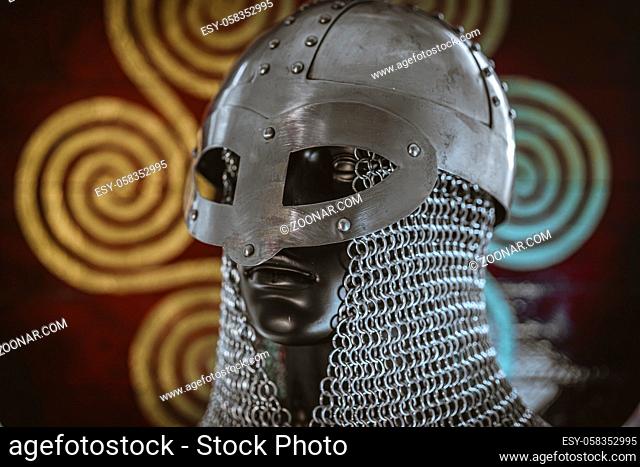 Costume Vikings, viking helmet with chain mail on a red shield with golden shapes of sun, weapons for war