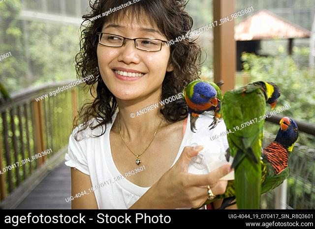 Woman with lorikeet Jurong Bird Park Singapore