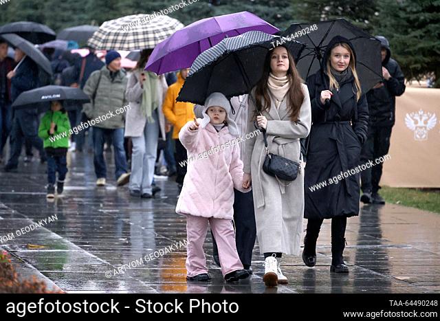 RUSSIA, MOSCOW - NOVEMBER 6, 2023: People walk under umbrellas during the rain at the VDNKh exhibition centre. Artyom Geodakyan/TASS