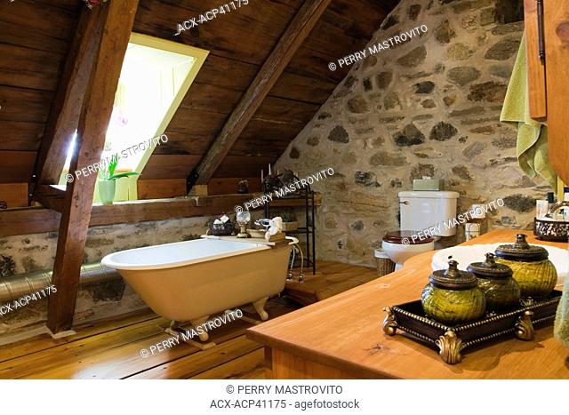 Bathroom on the upstairs floor of an Old Canadiana 1722 cottage style fieldstone and wooden siding Residential Home, Quebec, Canada