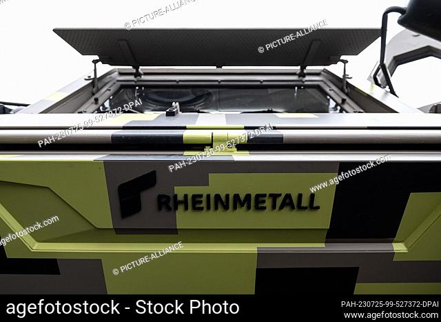 25 July 2023, Hesse, Kassel: The lettering ""Rheinmetall"" can be seen on a Fuchs tank. Rhein informs himself about the company's activities and projects at the...