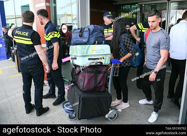 GEORGIA, TBILISI - MAY 19, 2023: Travellers emerge from Shota Rustaveli Tbilisi International Airport where an Azimuth flight from Moscow arrives