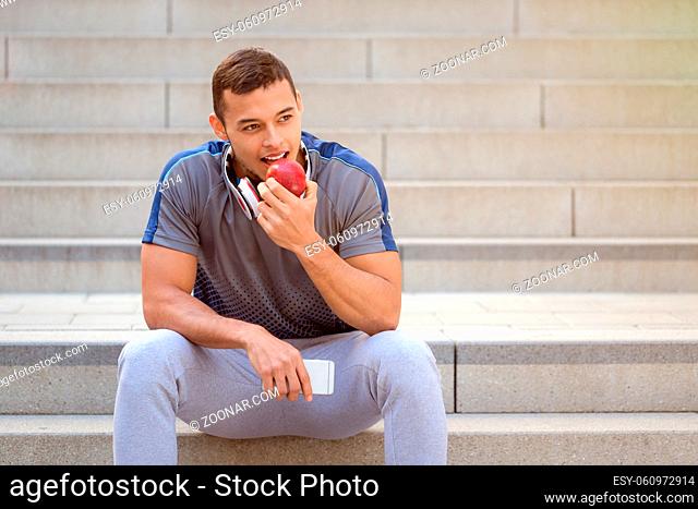 Eating apple fruit runner young man copyspace copy space sports training fitness outdoor
