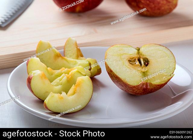 fresh healthy sliced apple on white plate