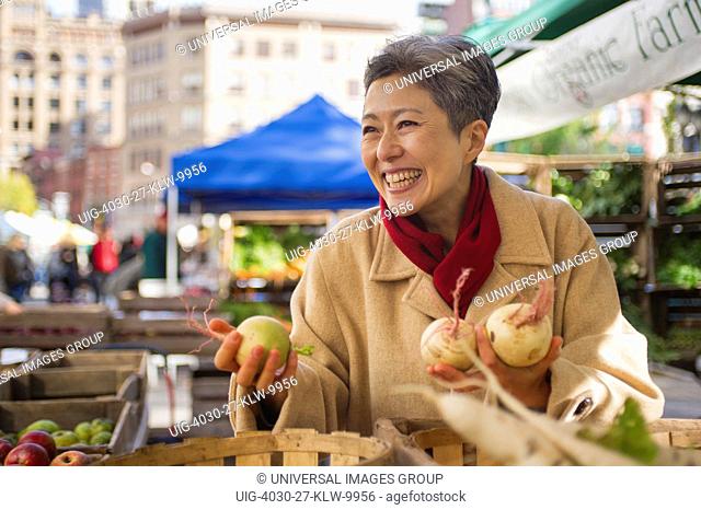 Woman Shopping For Vegetables At Public Market