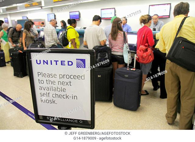 Florida, Miami, Miami International Airport, MIA, terminal, economy class, ticket counter, line, queue, passengers, self check-in, luggage, man, woman