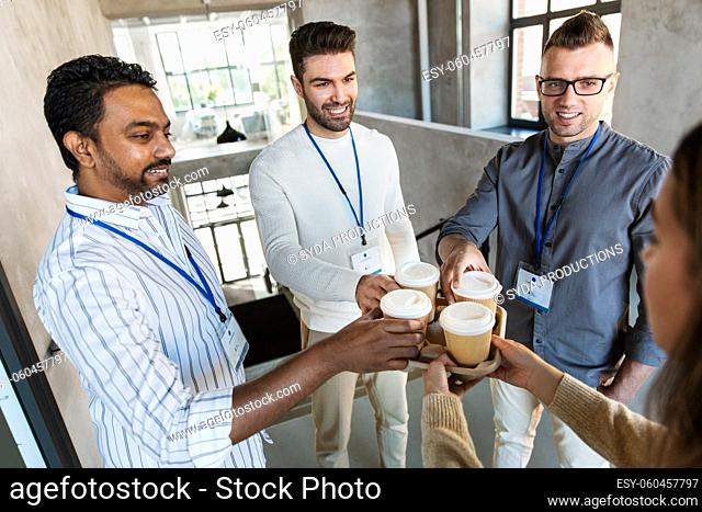 business people drinking takeaway coffee at office