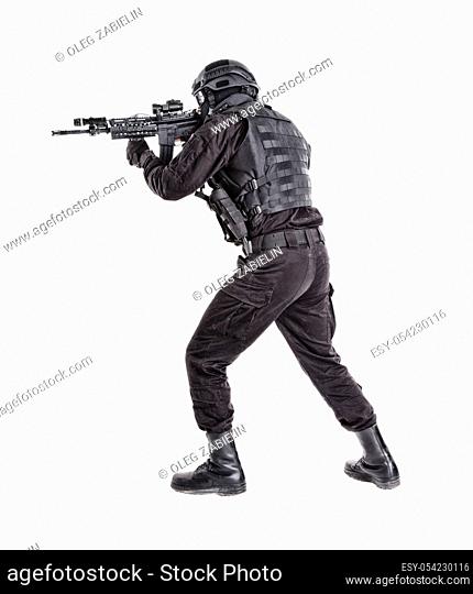 Police anti terrorism squad fighter, SWAT team shooter ready for fight, moving forward with wariness, keeping weapon ready for shoot