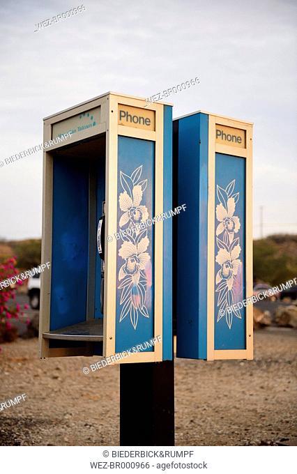 USA, Hawaii, Big Island, Hapuna Beach, public phone ornate with stylized Hawaiian hibiscus