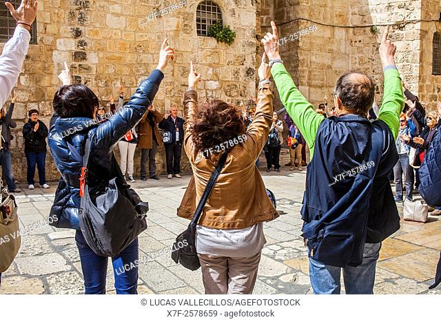 Pilgrims following Jesus' steps on the Via Dolorosa, in exterior of Church of the Holy Sepulchre also called the Church of the Resurrection, Christian Quarter