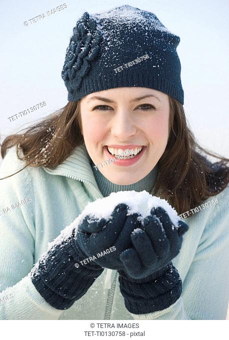 Woman holding handful of snow