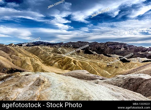 A picturesque desert-Scene with heavily eroded Ridges taken at the well-known Zabriskie Point, Death Valley National Park, California, USA
