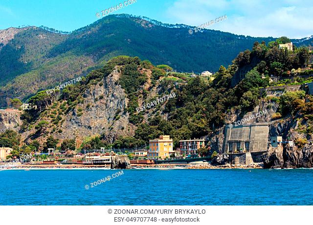 Summer Monterosso view from excursion ship. One of five famous villages of Cinque Terre National Park in Liguria, Italy, suspended between Ligurian sea and land...