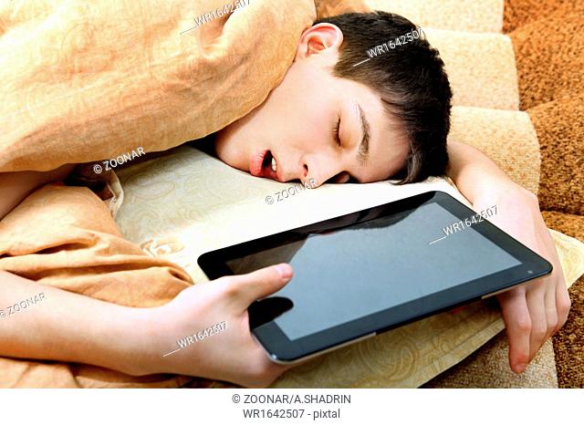 Teenager sleeps with Tablet