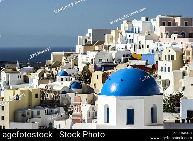 The architecture of Oia to include the white-washed/pastel edifices and the famed blue church domes. Santorini, Greece, Europe