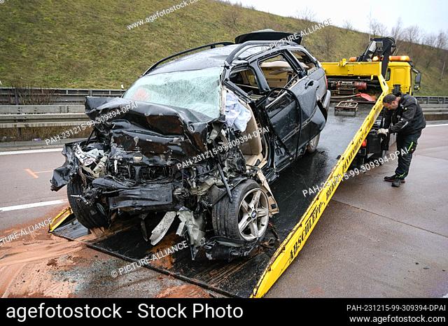 15 December 2023, Saxony-Anhalt, Querfurt: A car involved in the serious accident with a fan driver on the A38 is towed onto a recovery vehicle