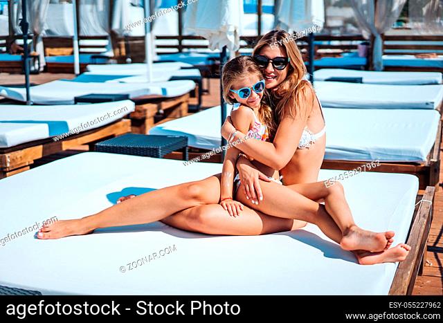 Mom and daughter on vacation posing on cameran