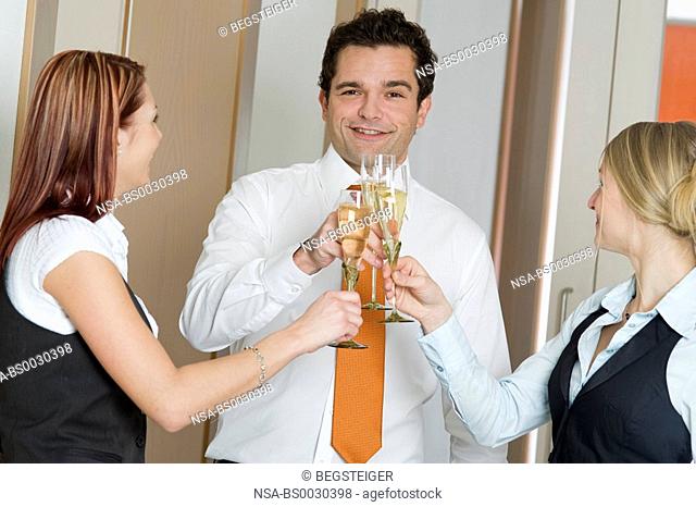 three business people drinking sparkling wine