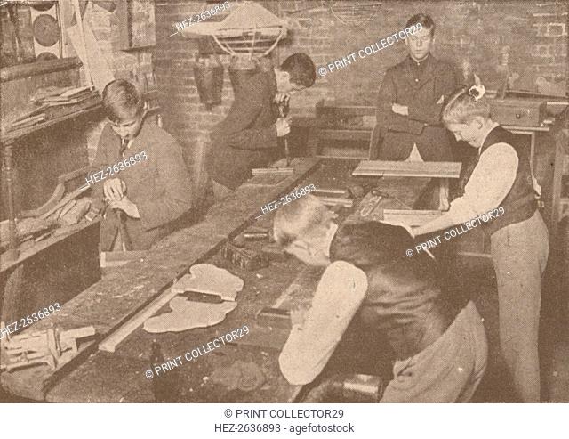Boys of Harrow School making splints, crutches and other articles for the wounded, c1916 (1928). Artist: Unknown