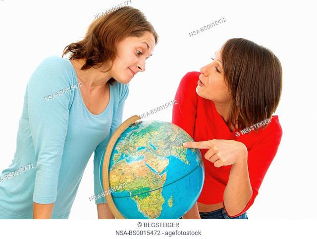 two girl friends with globe