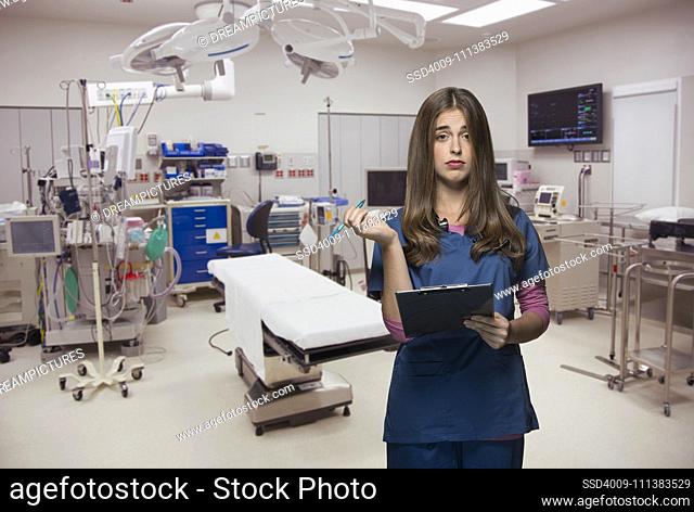 Overworked nurse holding clipboard in hospital room